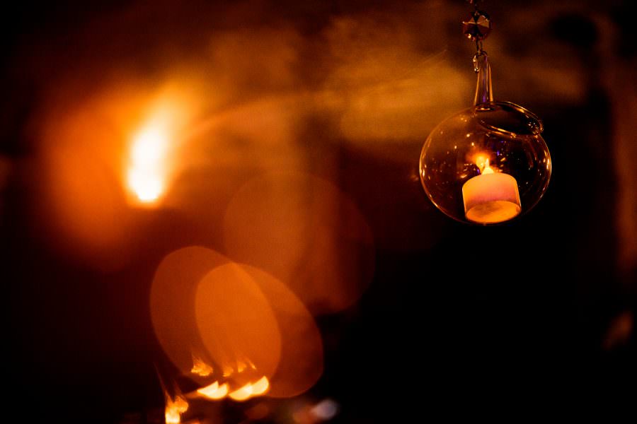 candle hanging from ceiling beautiful lighting at wedding reception at San Jose El Viejo in Antigua, Guatemala.