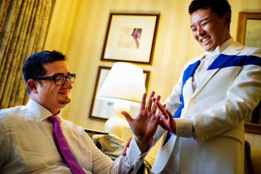 Same-sex wedding Grooms admire new wedding rings