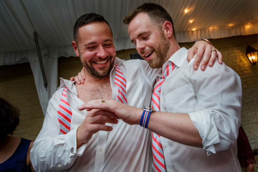 Groom admire their wedding rings at gay wedding in Charleston