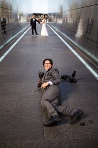 Destination wedding photographer Mauricio Arias lays on the ground for a photo in New Jersey.