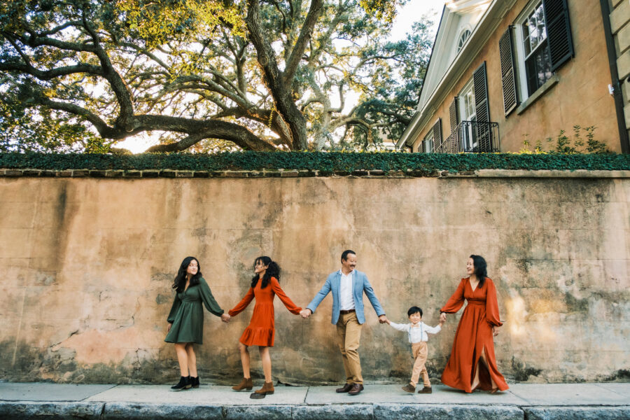 A family walks around historic downtown Charleston during their family portrait session with Chrisman Studios