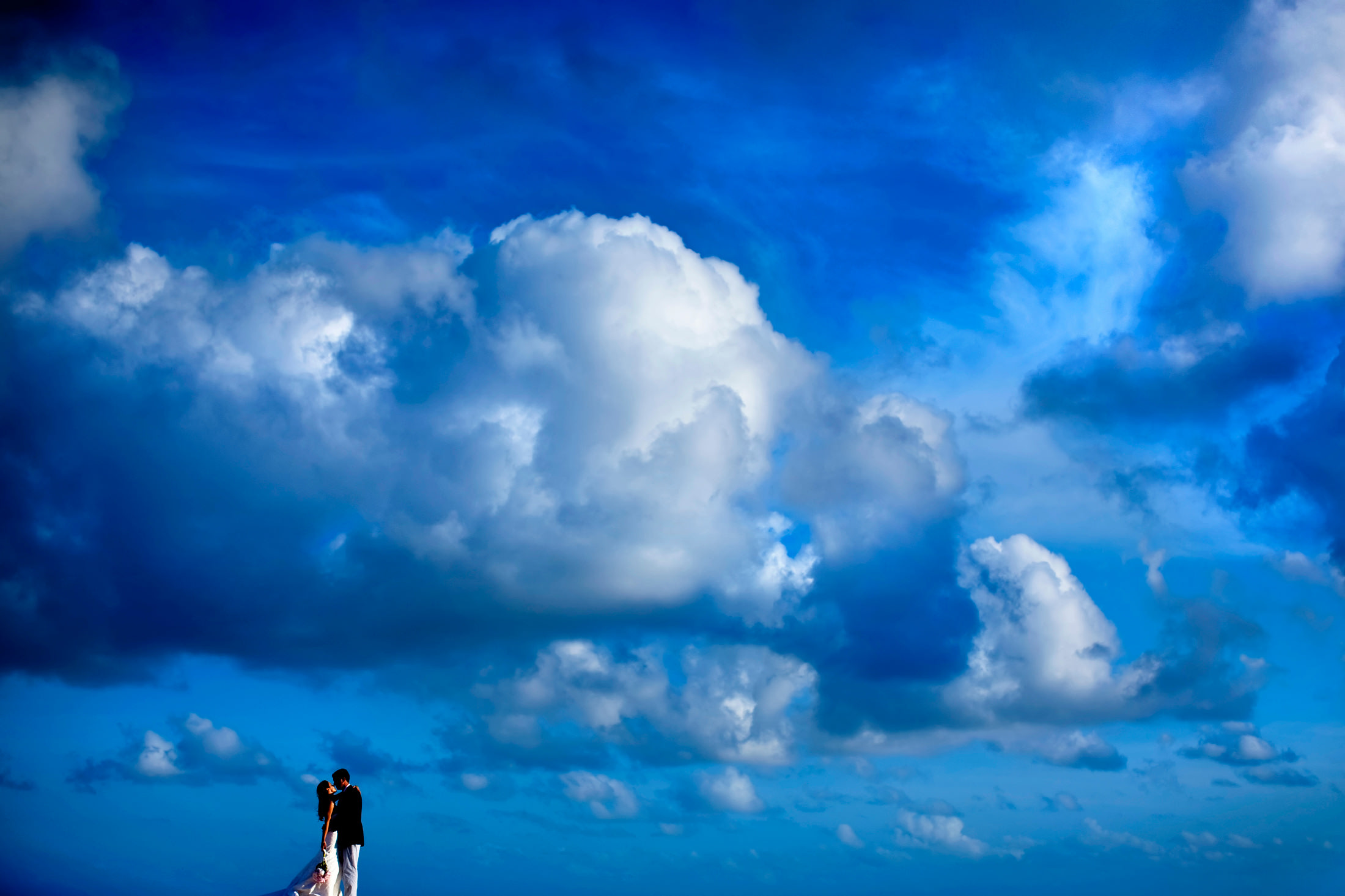 A bride and groom portrait under a big blue sky in Bermuda.
